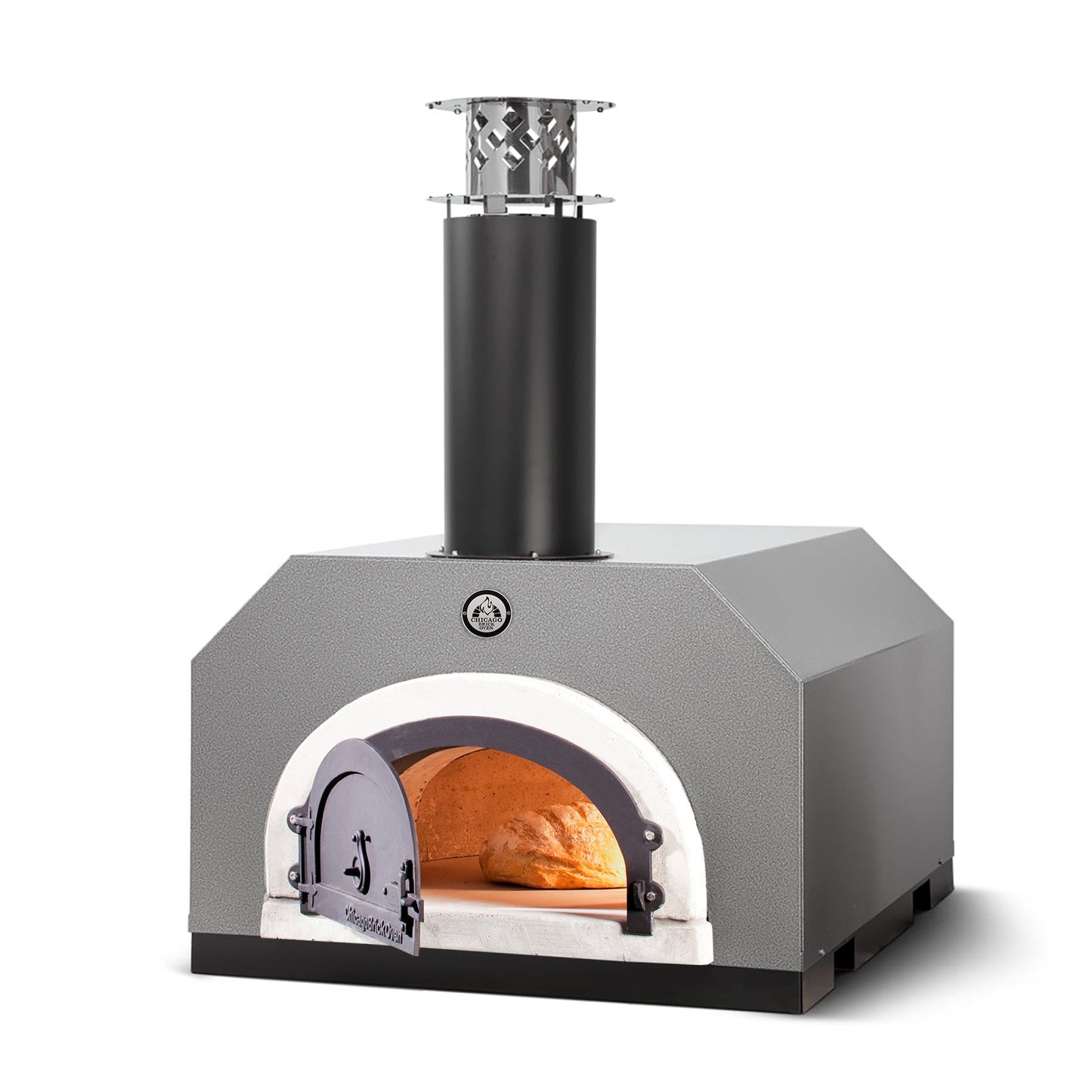 The Chicago Brick Oven CBO 500 Countertop Wood Fired Pizza Oven features a sleek grey metal exterior with a black chimney on top. The oven door is ajar, showcasing an inviting orange glow from the fire and a partially cooked pizza inside, all thanks to its commercial grade refractory cement lining. The oven is positioned on a sturdy black base and offers a 27" x 22" cooking surface for your culinary creations.