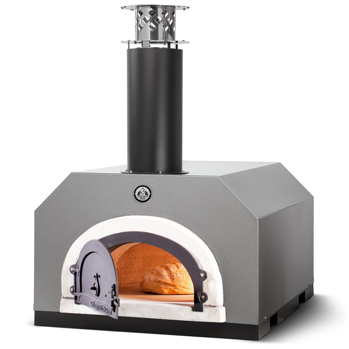 The CBO 750 Countertop Wood Fired Pizza Oven by Chicago Brick Oven boasts a gray, domed interior, a prominent black chimney, and a small arched door featuring an illustration of a person. Inside, the Signature FlameRoll® wood-fired oven bakes a loaf of bread with a warm glow from the fire on its 38" x 28" cooking surface.