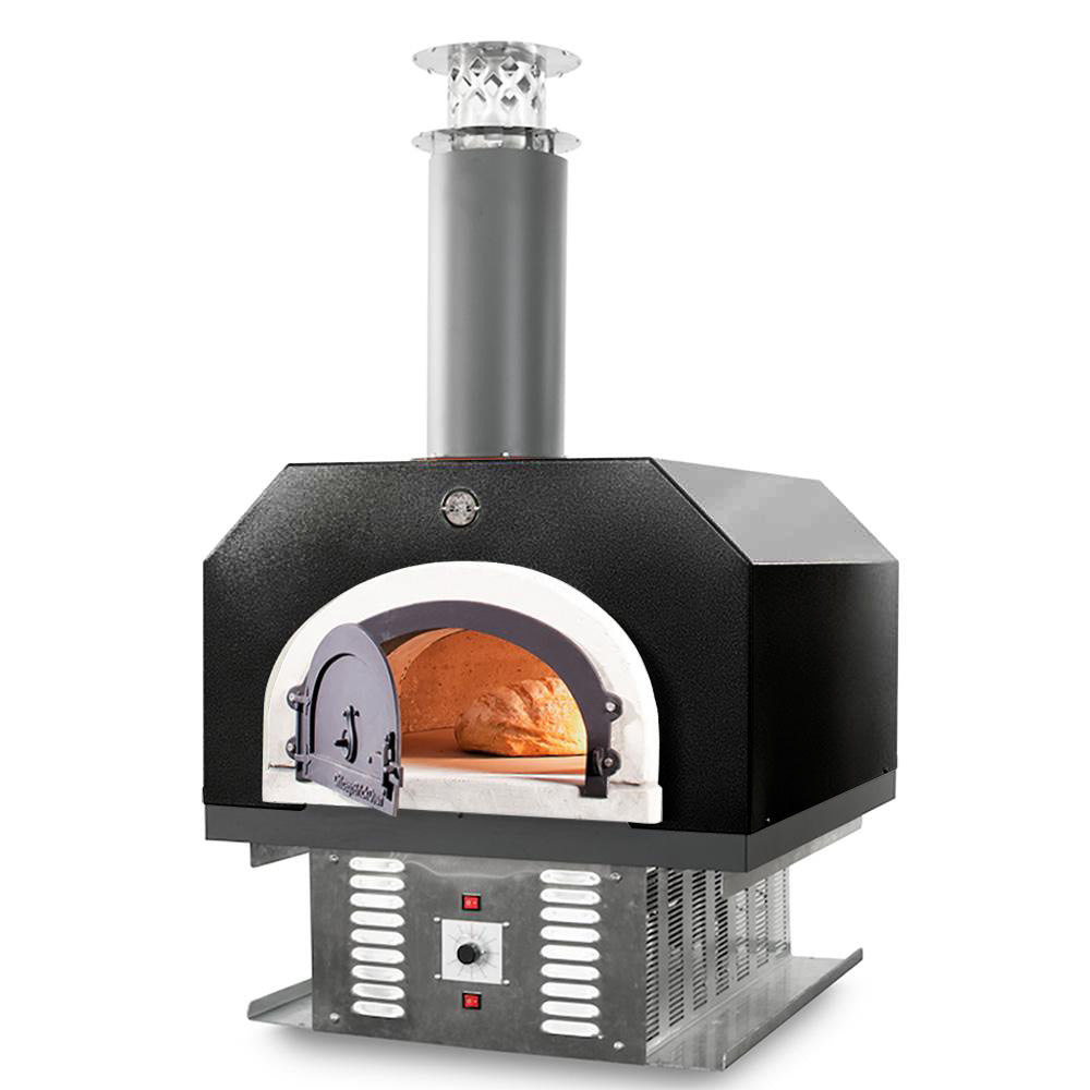 A black, rectangular Chicago Brick Oven CBO 750 Hybrid Countertop (Residential) No SKIRT Dual Fuel (Gas and Wood) oven with a chimney and metallic base is shown. The oven door is partially open, revealing the interior lit with a warm glow. Two control buttons are visible at the bottom of the oven base, highlighting its high-performance design perfect for outdoor pizza enthusiasts.